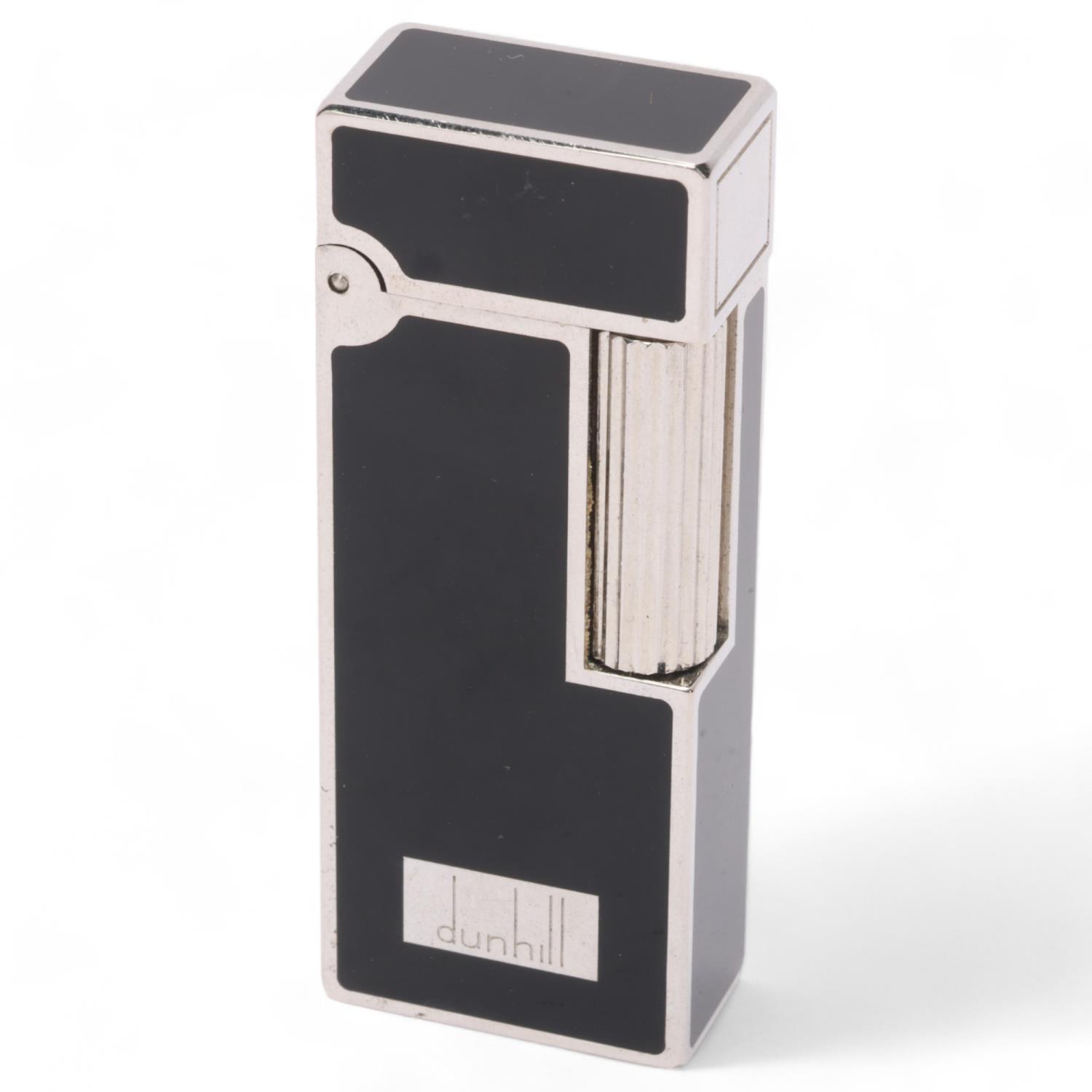 **WITHDRAWN** A vintage Dunhill silver plated Rollagas lighter, with black lacquer detail