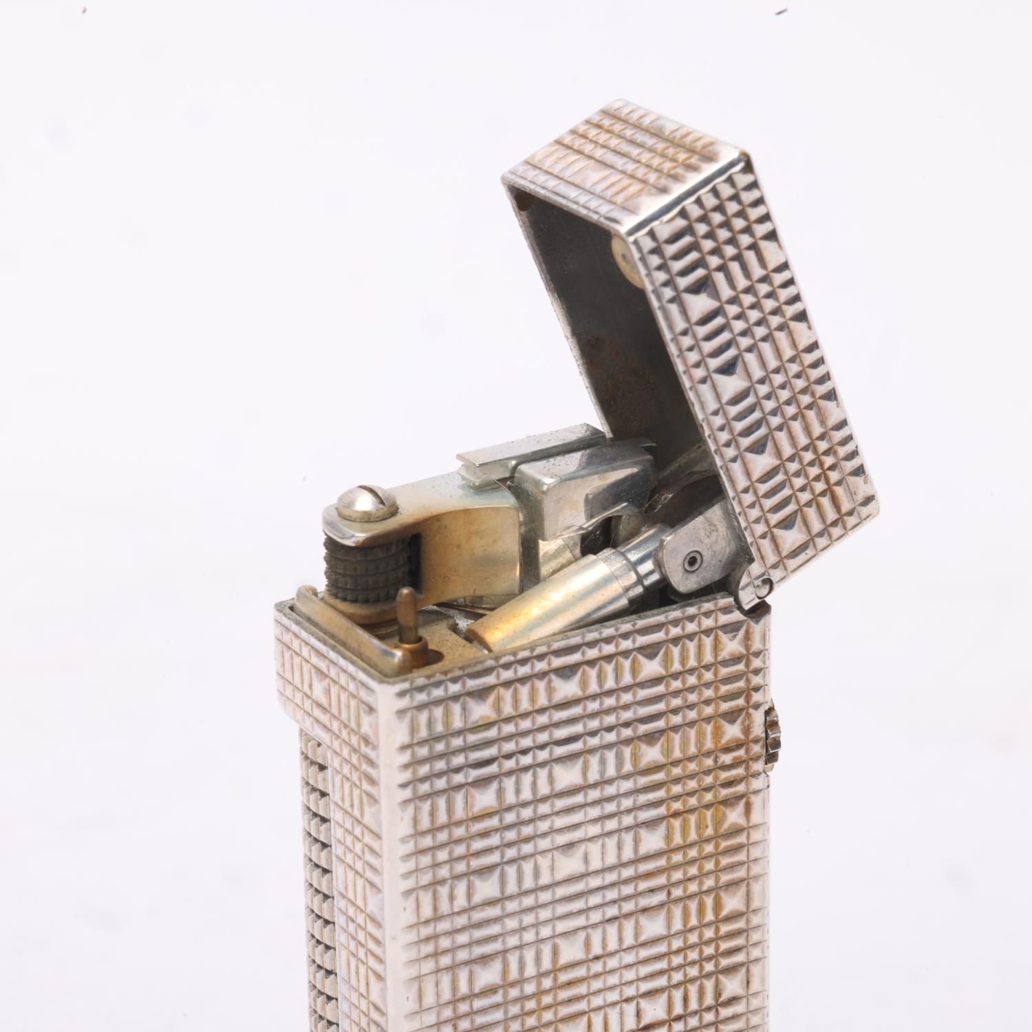 A vintage Dunhill Rollagas lighter, with silver plated textured body, makers marks to base, length - Image 4 of 4