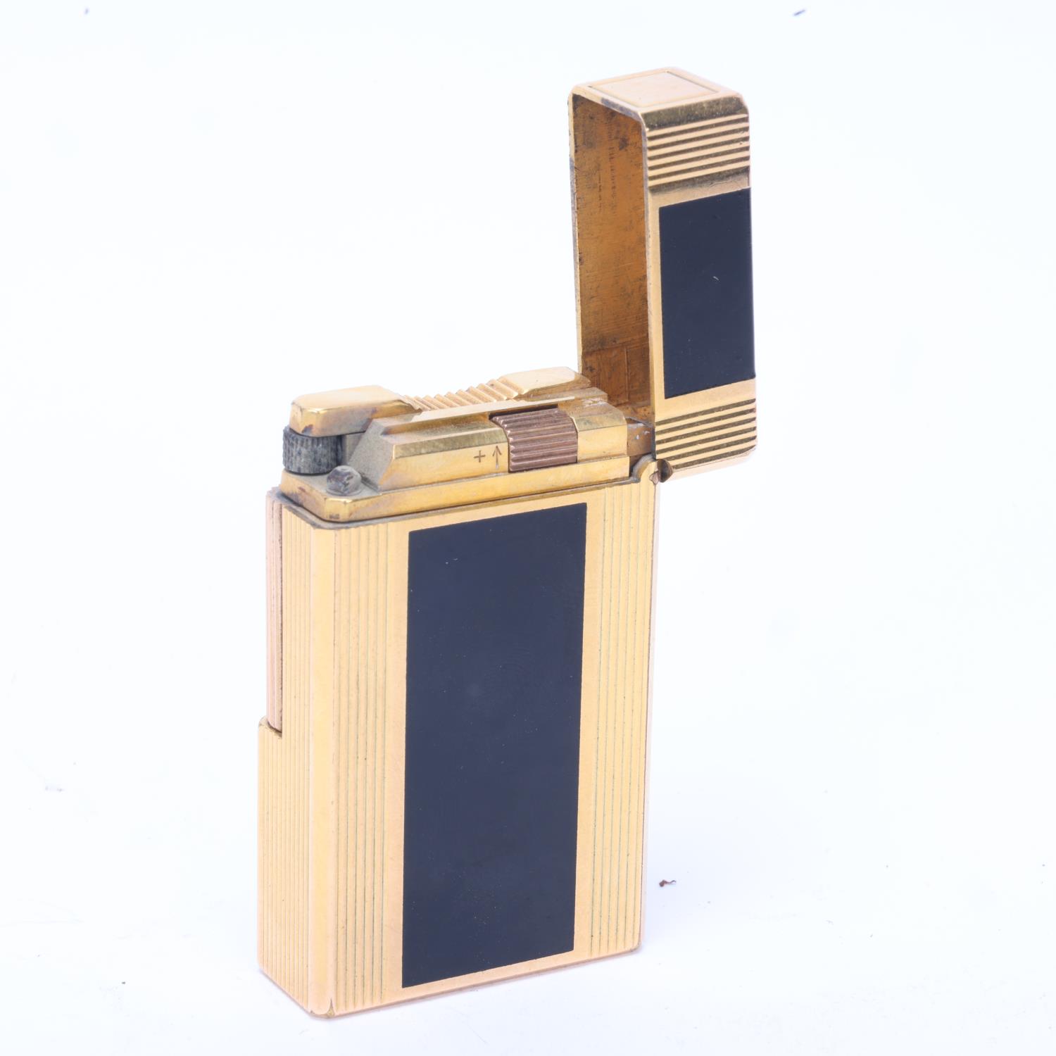 A vintage SJ Dupont lighter, gold plated and black lacquer, makers marks to base, model No Z7DG40? - Image 2 of 4