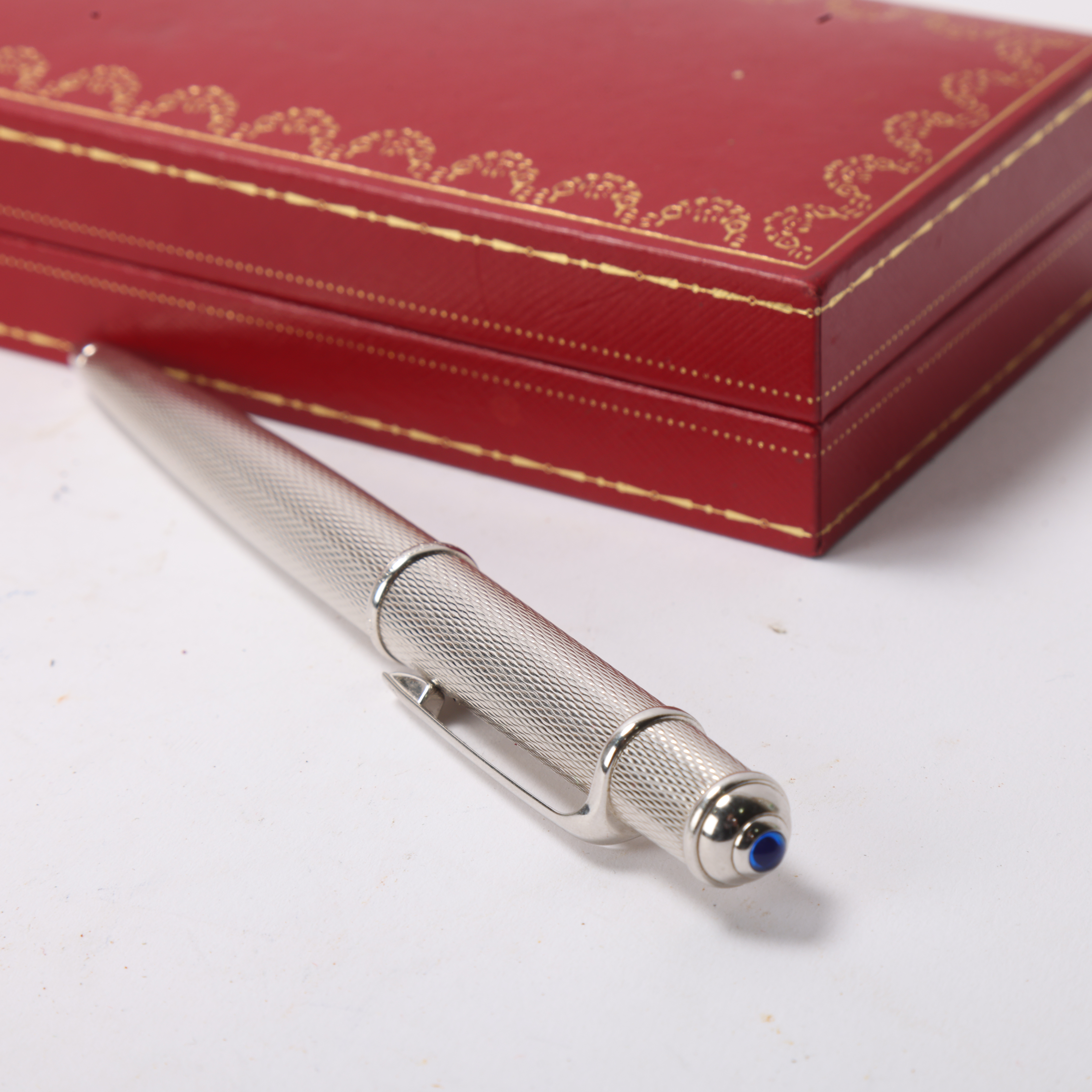 A Cartier "Diablo de Cartier" ballpoint pen, with engine turned steel body, original box and papers - Bild 3 aus 3