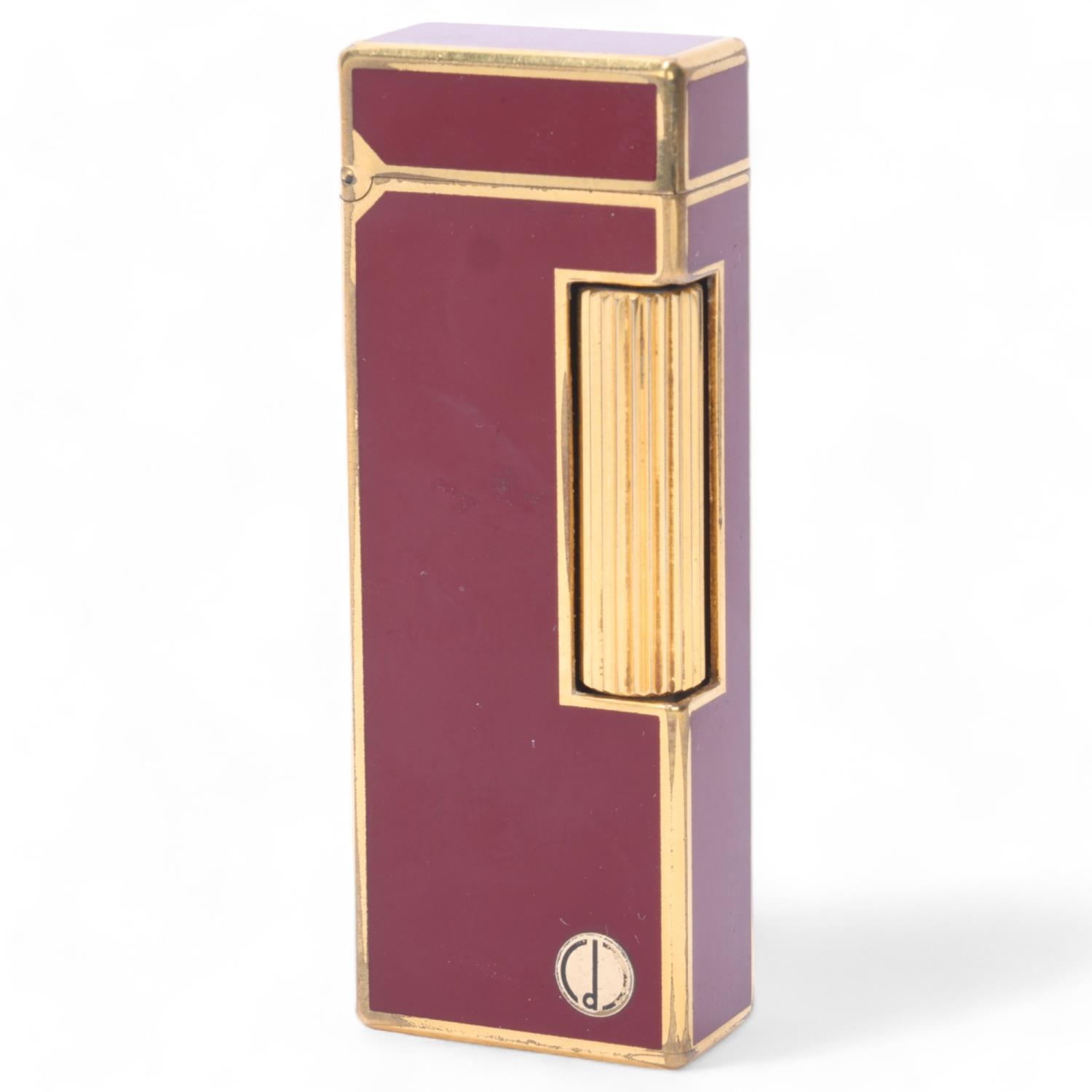 A vintage Dunhill Rollagas lighter, with gold plated and red lacquer body, makers marks to base,