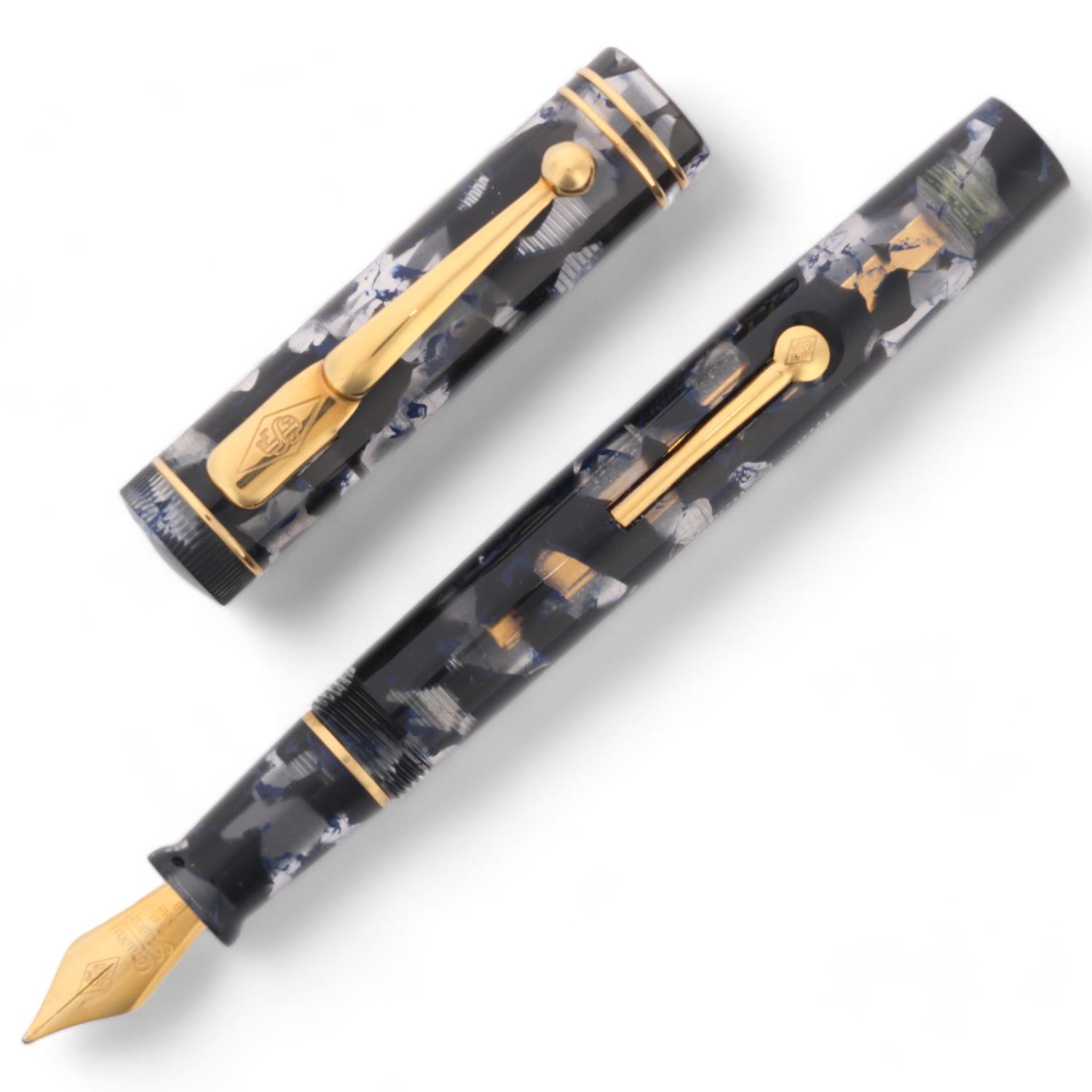 A limited edition Conway Stewart "Dandy" lever fill fountain pen, black and clear marble resin body,