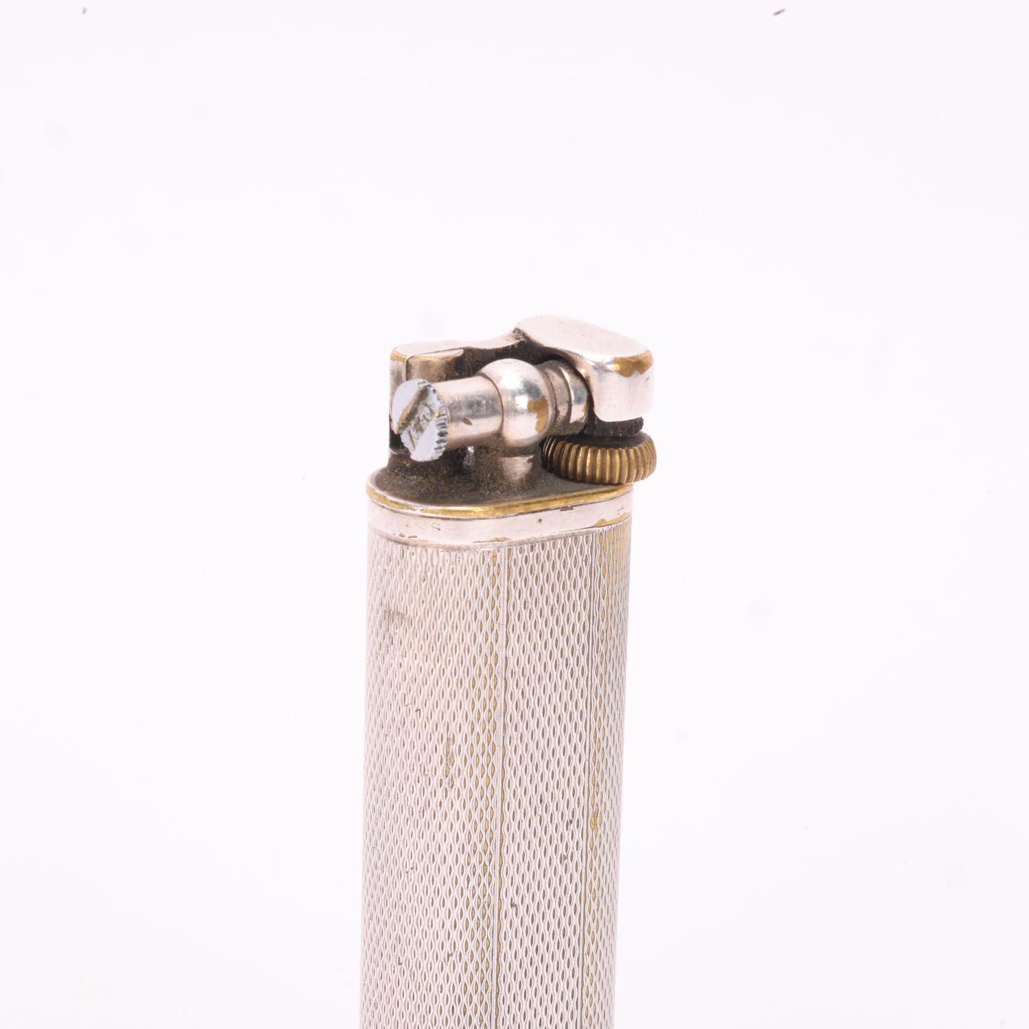 A vintage Dunhill silver plated lighter, slimline model with hammer arm, makers marks to base, - Bild 2 aus 4