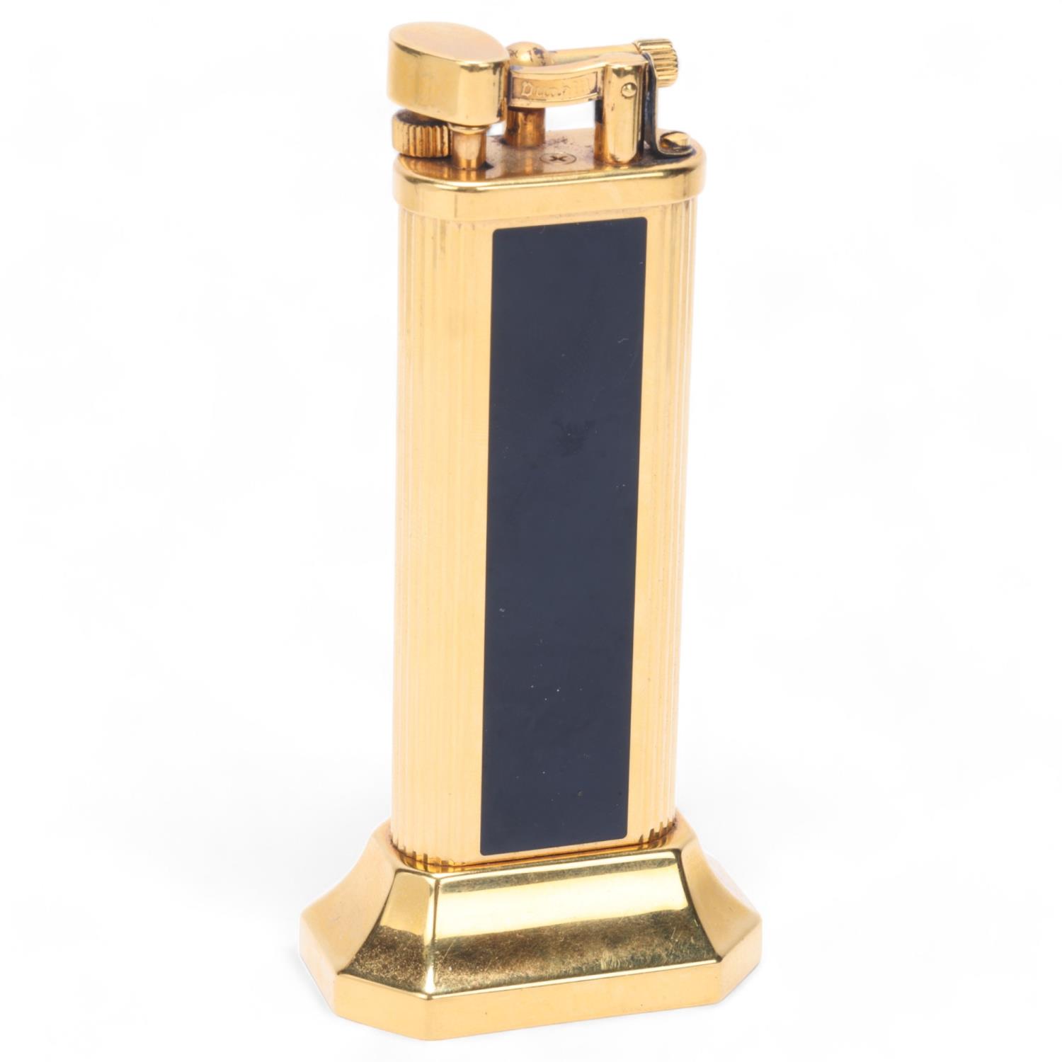 A vintage Dunhill gold plated table lighter, with black lacquer panels, makers marks to base, No