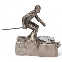 A Comoys table lighter in a a downhill skier aluminium base, height 12.5cm Skier is missing 1