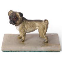 A painted spelter study of a standing Pug dog, with gilded collar, H6cm, mounted on an alabaster