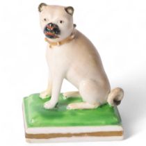 A 19th century porcelain seated Pug, possibly Derby, on painted square base, with gold studded