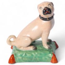 Derby, a 19th century study of a Pug, on a painted cushion base, with a painted black collar, H9.5cm