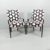 A pair of designer armchairs upholstered in playing cards velvet and cotton fabric.