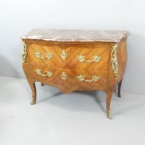 A French kingwood veneered and satinwood strung commode chest of two drawers, with ormulu rococo