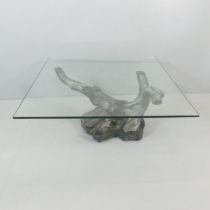 A mid-century square glass topped coffee table on bronzed finish branching tree stump base, in the