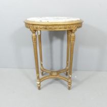 A French oval marble-topped occasional table, on gilt painted base, with carved and fluted