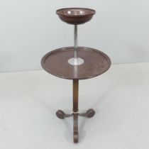 An Art Deco cast iron and Bakelite two-tier smoker's companion stand.