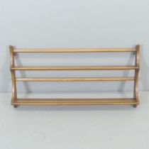 ERCOL - A mid-century elm two-tier hanging plate rack. 97x50x11cm.