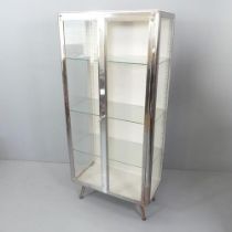 A 1950s glazed medical or dentist's cabinet, with 3 adjustable shelves.75x165x41cm.