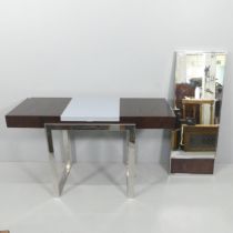 A contemporary dressing table, with lifting lid and two frieze drawers, and raised on metal sled