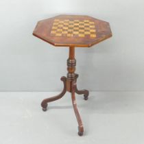 A 19th century mahogany octagonal games top table, on tripod base, width 44.5cm, height 73cm.