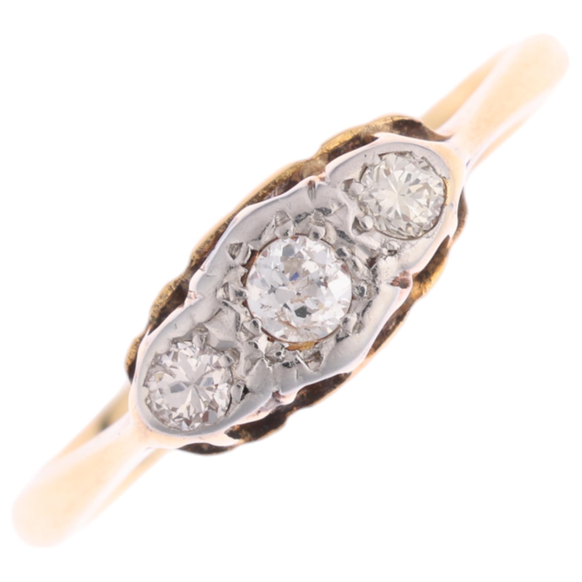 An 18ct gold three stone diamond ring, platinum-topped set with round brilliant-cut diamonds,