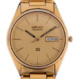 SEIKO - a gold plated stainless steel SQ quartz bracelet watch, ref. 5H23-8A00, champagne dial