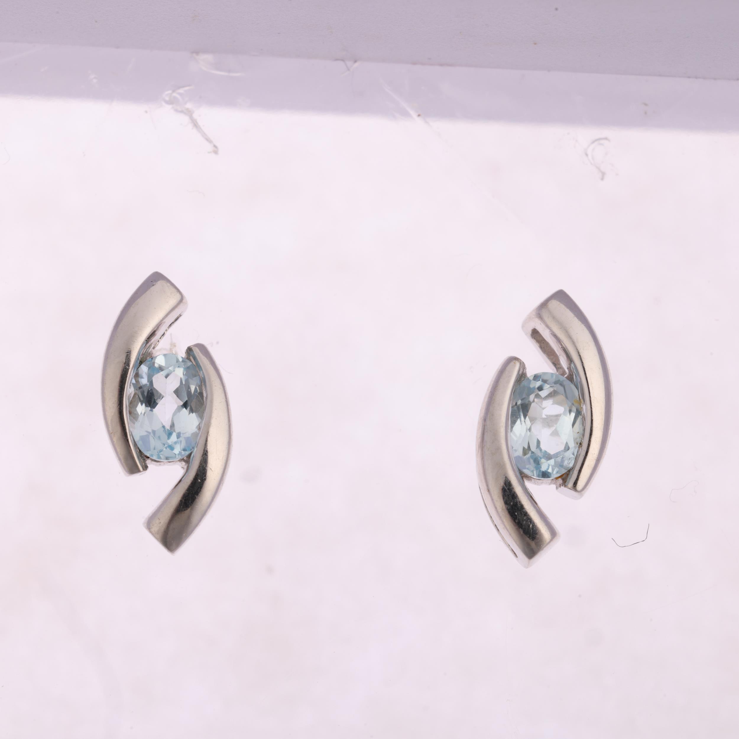 A pair of 9ct white gold blue topaz earrings, with stud fittings, 10.8mm, 1.4g Condition Report: - Image 2 of 4