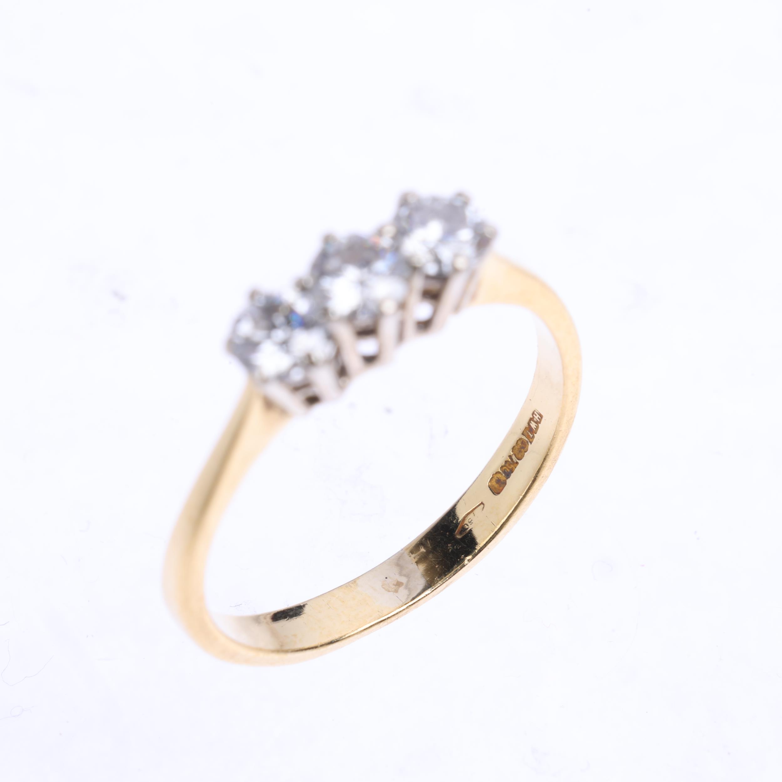 An 18ct gold three stone diamond ring, maker HWT, claw set with modern round brilliant-cut diamonds, - Image 3 of 4