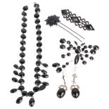 Various French jet black glass jewellery, including fringe necklace, butterfly brooch, flower