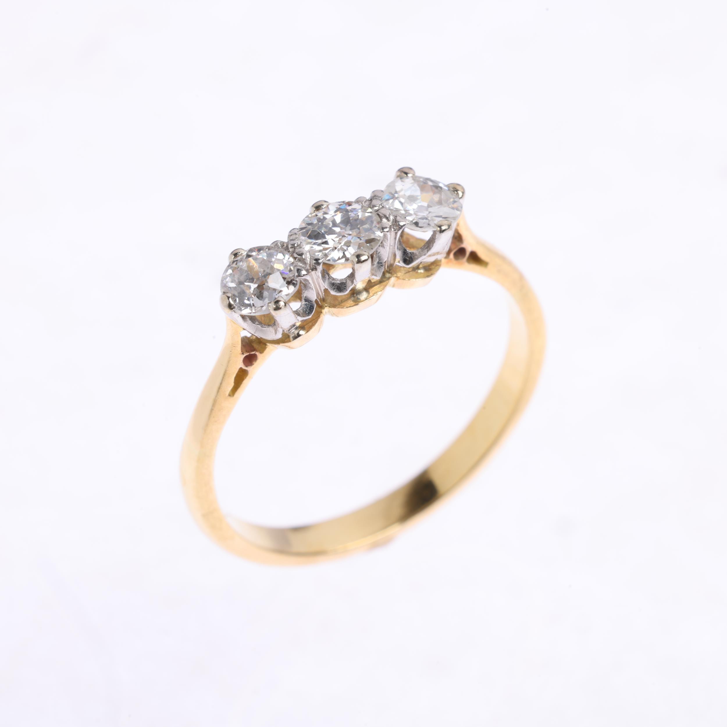 A three stone diamond ring, claw set with old European-cut diamonds, total diamond content approx - Image 2 of 4