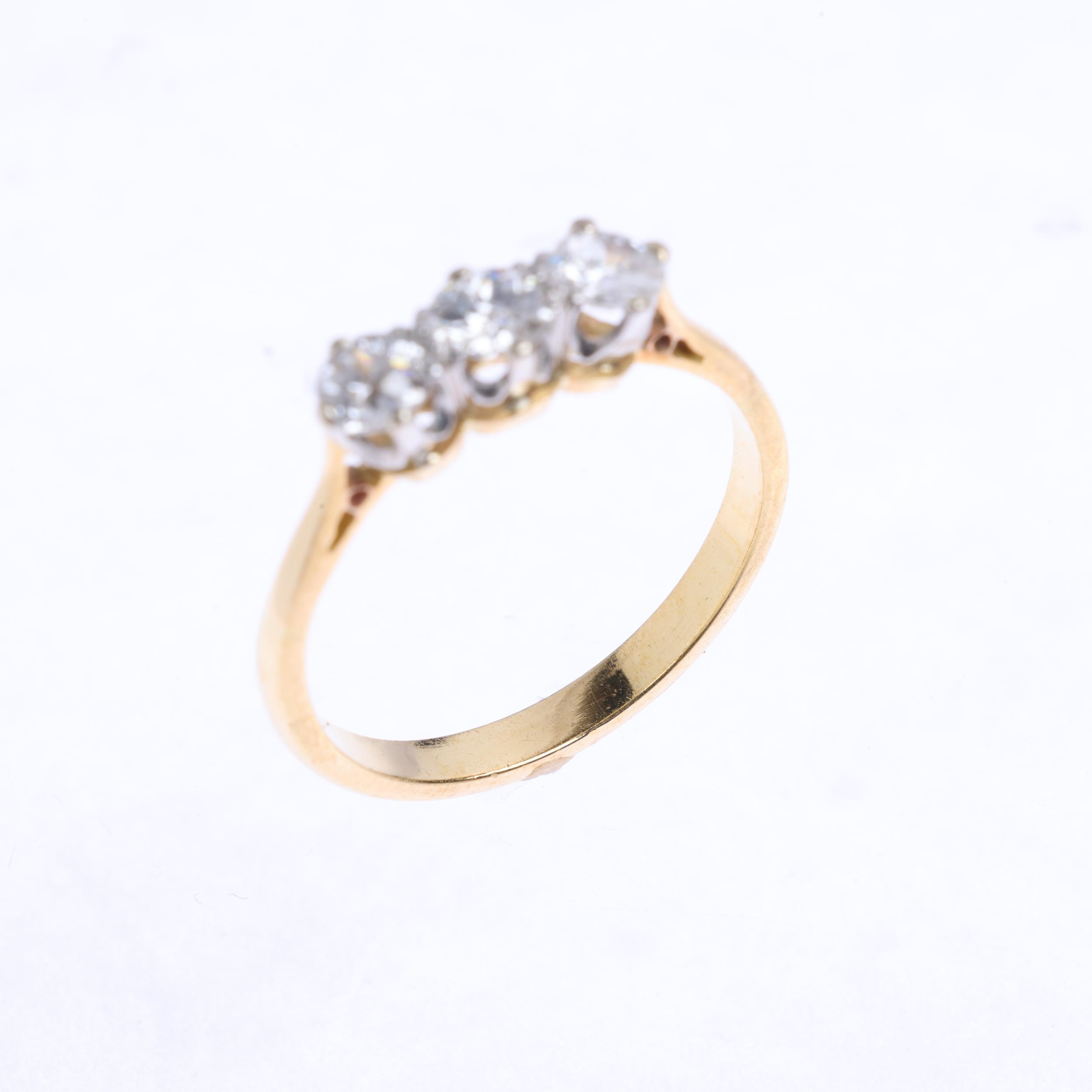 A three stone diamond ring, claw set with old European-cut diamonds, total diamond content approx - Image 3 of 4