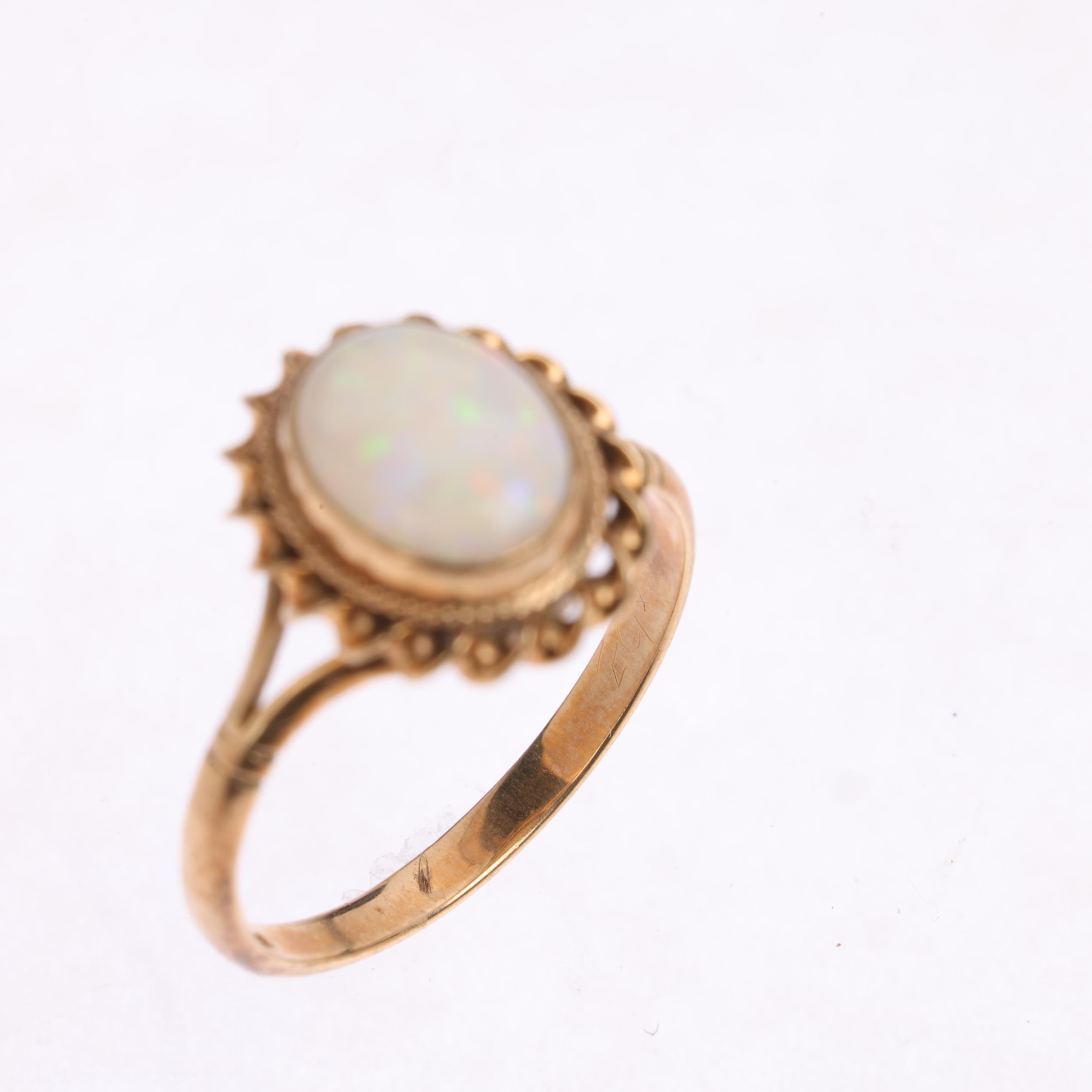 A 9ct gold solitaire opal dress ring, maker CG&S, Birmingham 1986, rub-over set with oval cabochon - Image 3 of 4