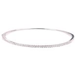 A modern 9ct white gold diamond hinged bangle, set with modern round brilliant-cut diamonds, band