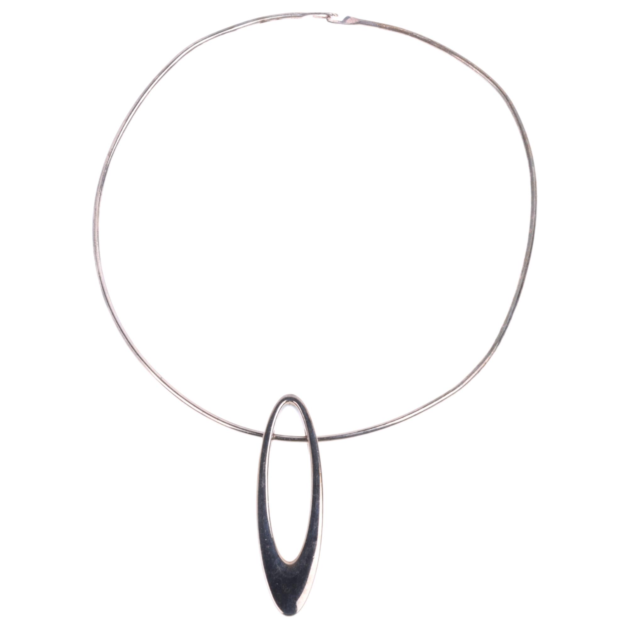 A sterling silver ellipse openwork pendant necklace, maker RS, on sterling neck torque, pendant 59.