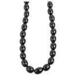 A single-strand graduated jet bead necklace, beads measure 14.2-10mm, 49cm, 37.2g Condition