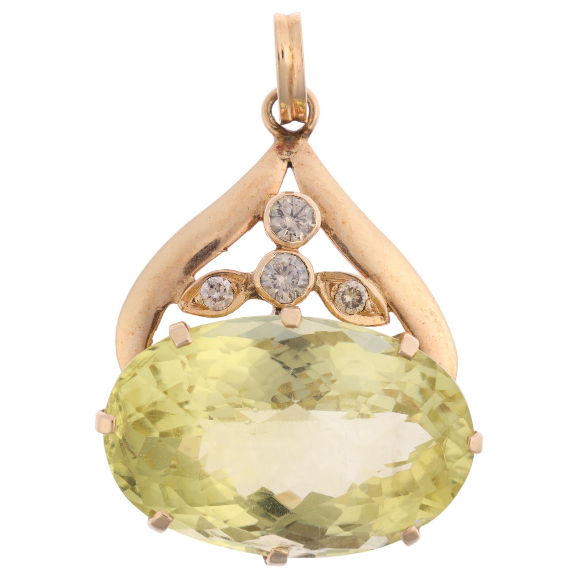 A 14ct gold lemon quartz and diamond pendant, claw set with oval rose-cut lemon quartz and modern