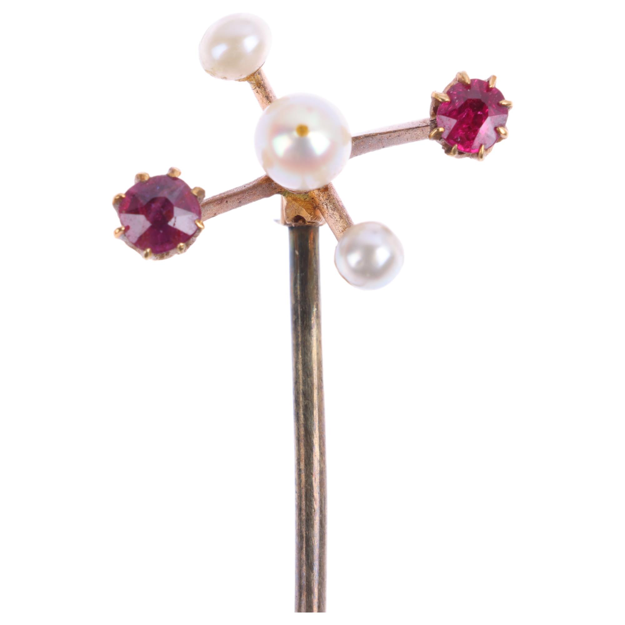 An Edwardian 15ct gold ruby and pearl stickpin, head 16.1mm, overall 63.5mm, 1.6g Condition