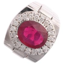 A large 14ct white gold ruby and diamond cluster signet ring, maker JI, centrally claw set with