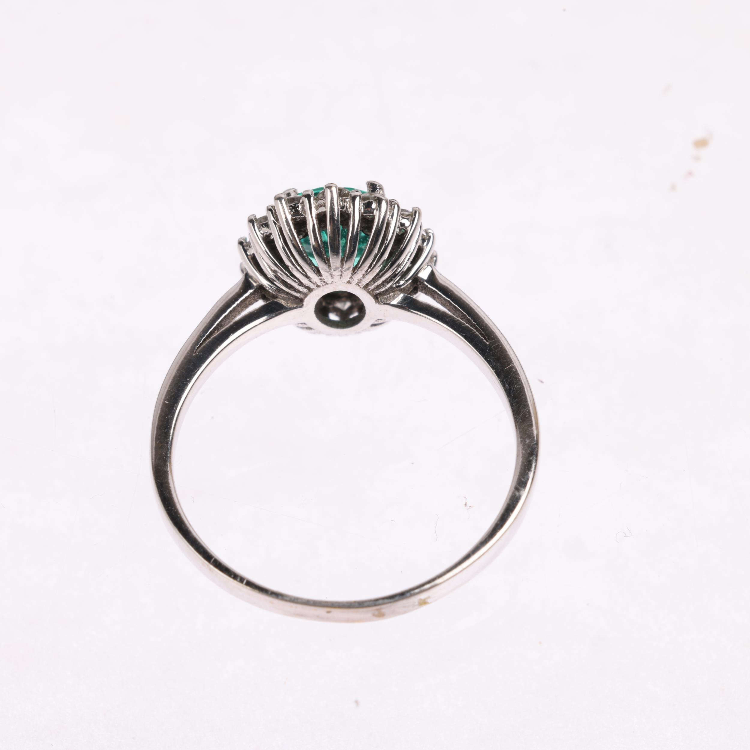 An emerald and diamond oval cluster ring, claw set with oval mixed-cut emerald and modern round - Image 3 of 4