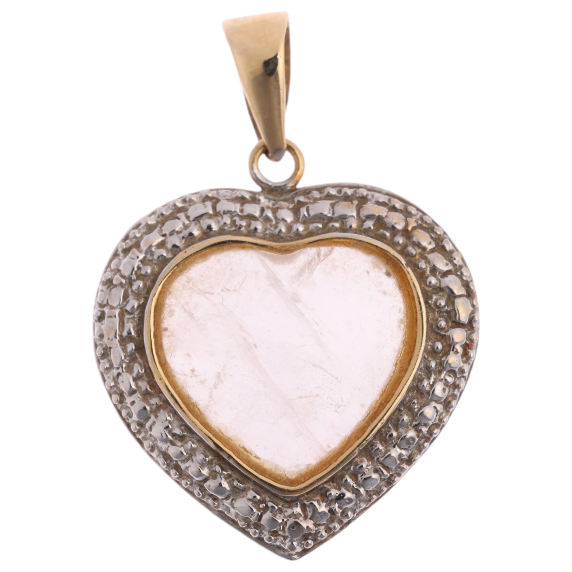 A 9ct gold moonstone heart pendant, 24.7mm, 2.3g Condition Report: No damage or repair, only light