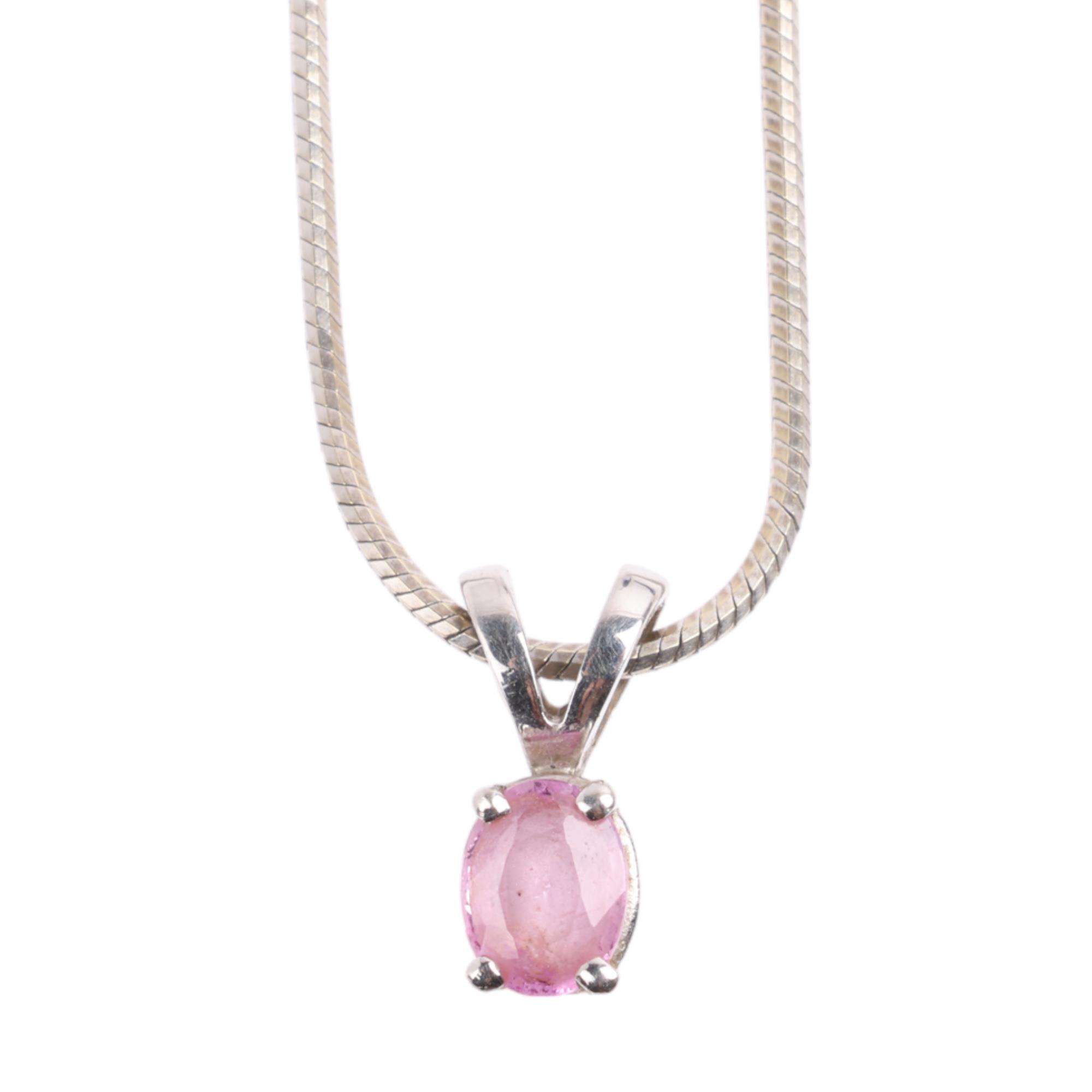 A 9ct white gold pink sapphire pendant necklace, on 9ct herringbone link chain, pendant 10.9mm,