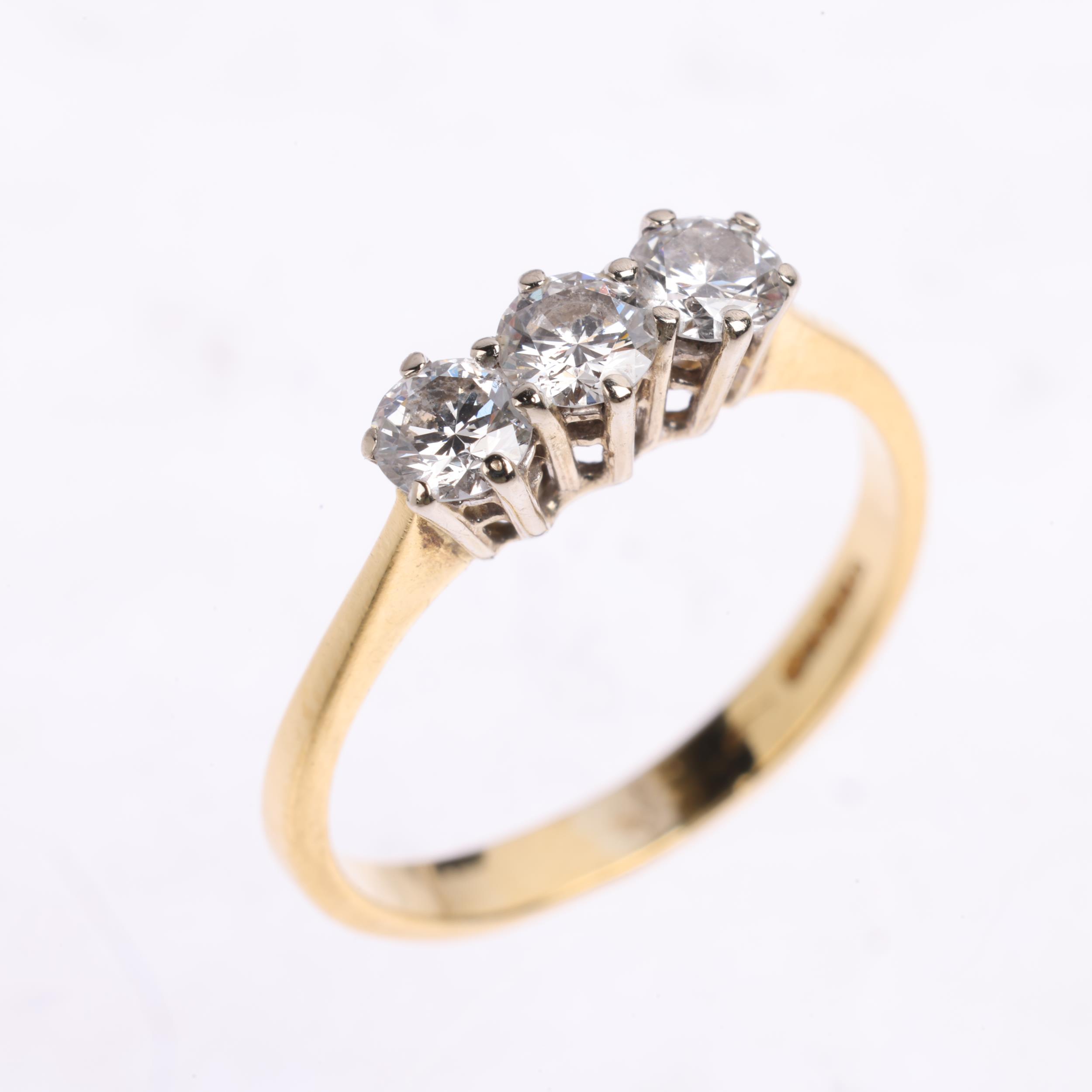 An 18ct gold three stone diamond ring, maker HWT, claw set with modern round brilliant-cut diamonds, - Image 2 of 4