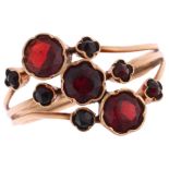 A French 9ct gold garnet flowerhead dress ring, setting height 13.6mm, size N, 1.9g Condition