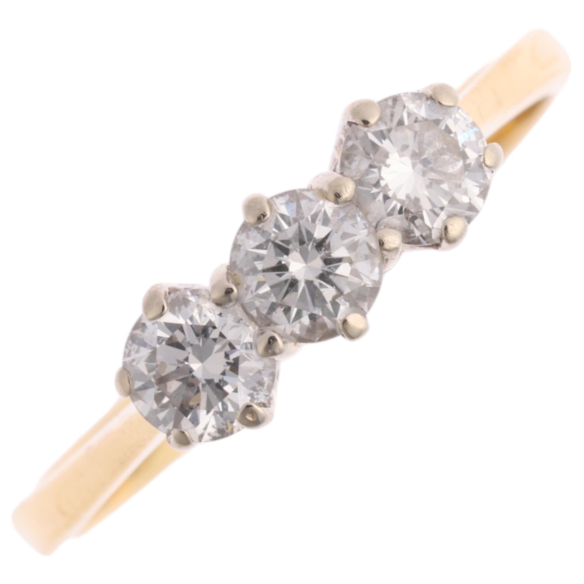 An 18ct gold three stone diamond ring, maker HWT, claw set with modern round brilliant-cut diamonds,