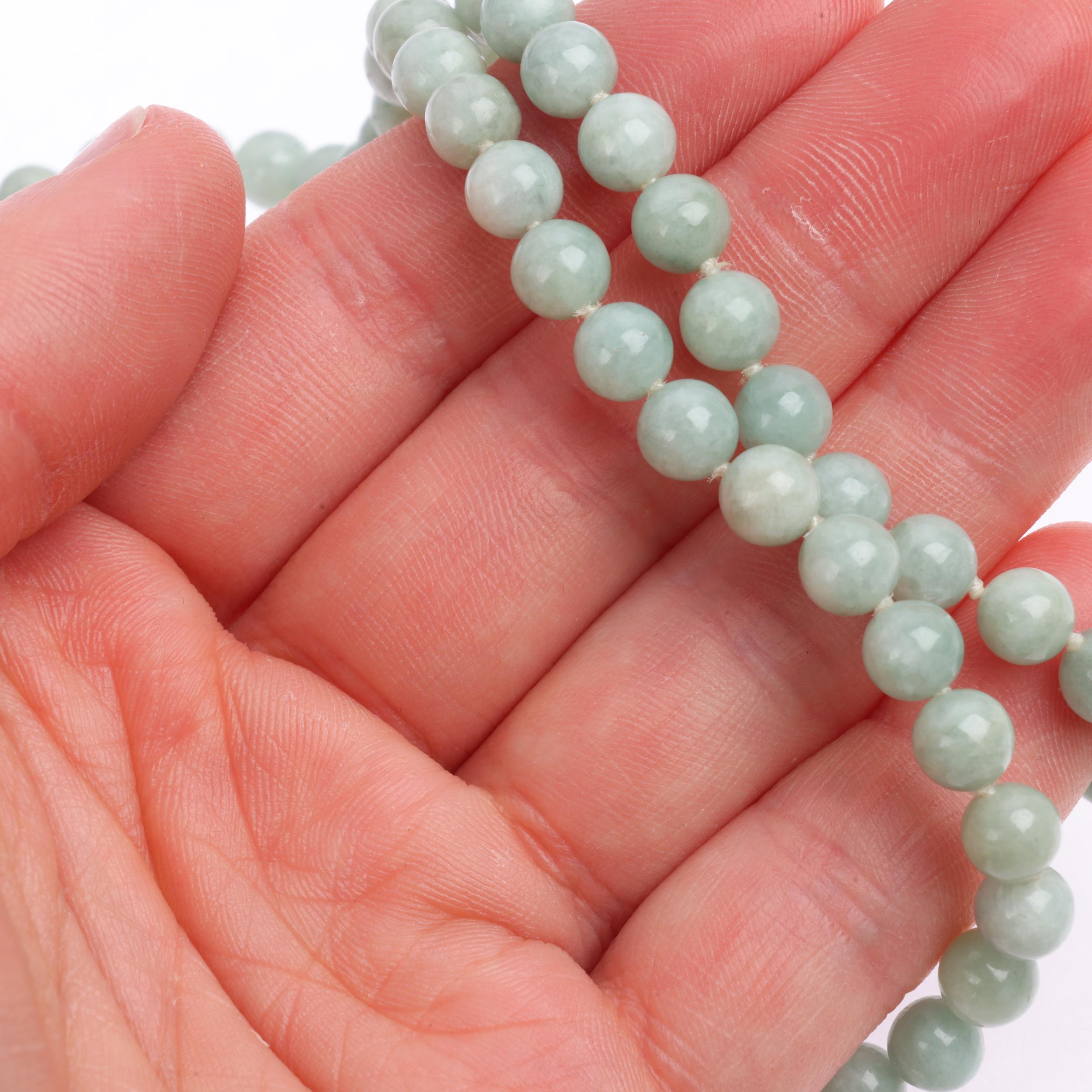 A single-row polished jade bead necklace, with 14ct gold clasp, beads measure 6.1mm, 44cm, 27.3g - Image 4 of 4