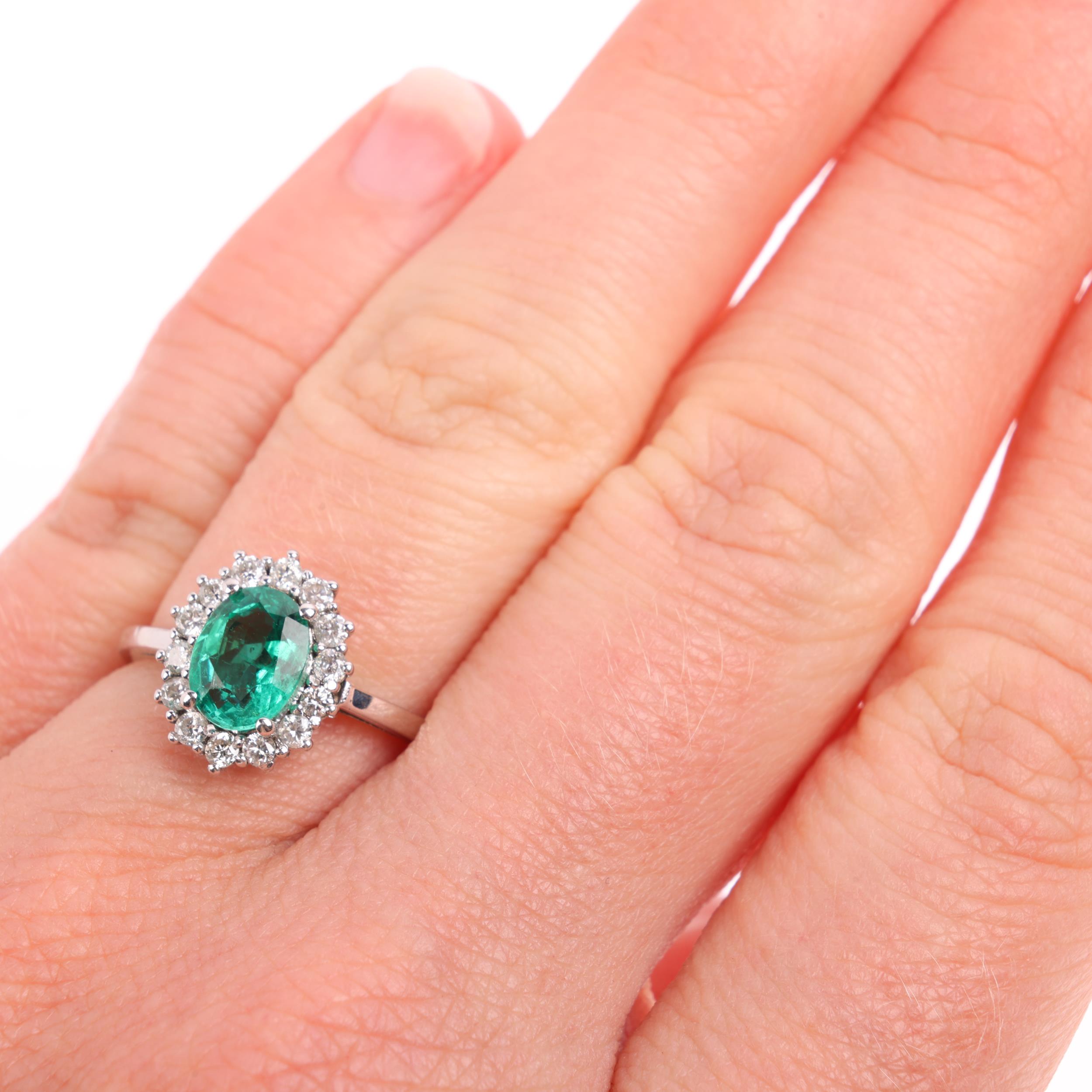 An emerald and diamond oval cluster ring, claw set with oval mixed-cut emerald and modern round - Image 4 of 4
