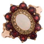 A 9ct gold opal and garnet flowerhead cluster ring, maker G&TJ, London 1975, set with oval