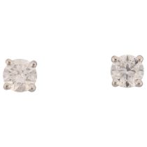 A pair of 18ct white gold 1.01ct solitaire diamond stud earrings, each claw set with individually