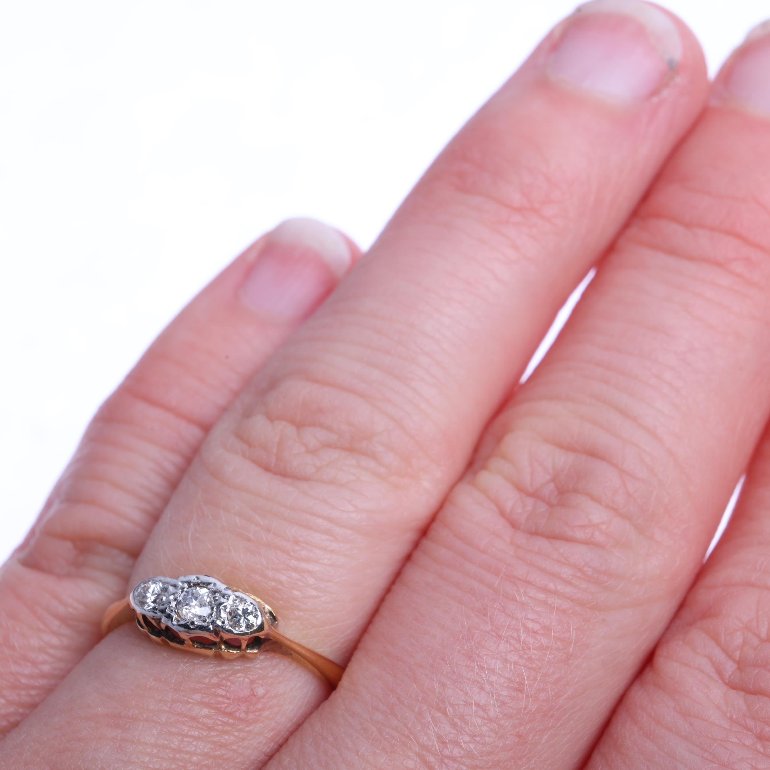 An 18ct gold three stone diamond ring, platinum-topped set with round brilliant-cut diamonds, - Image 4 of 4