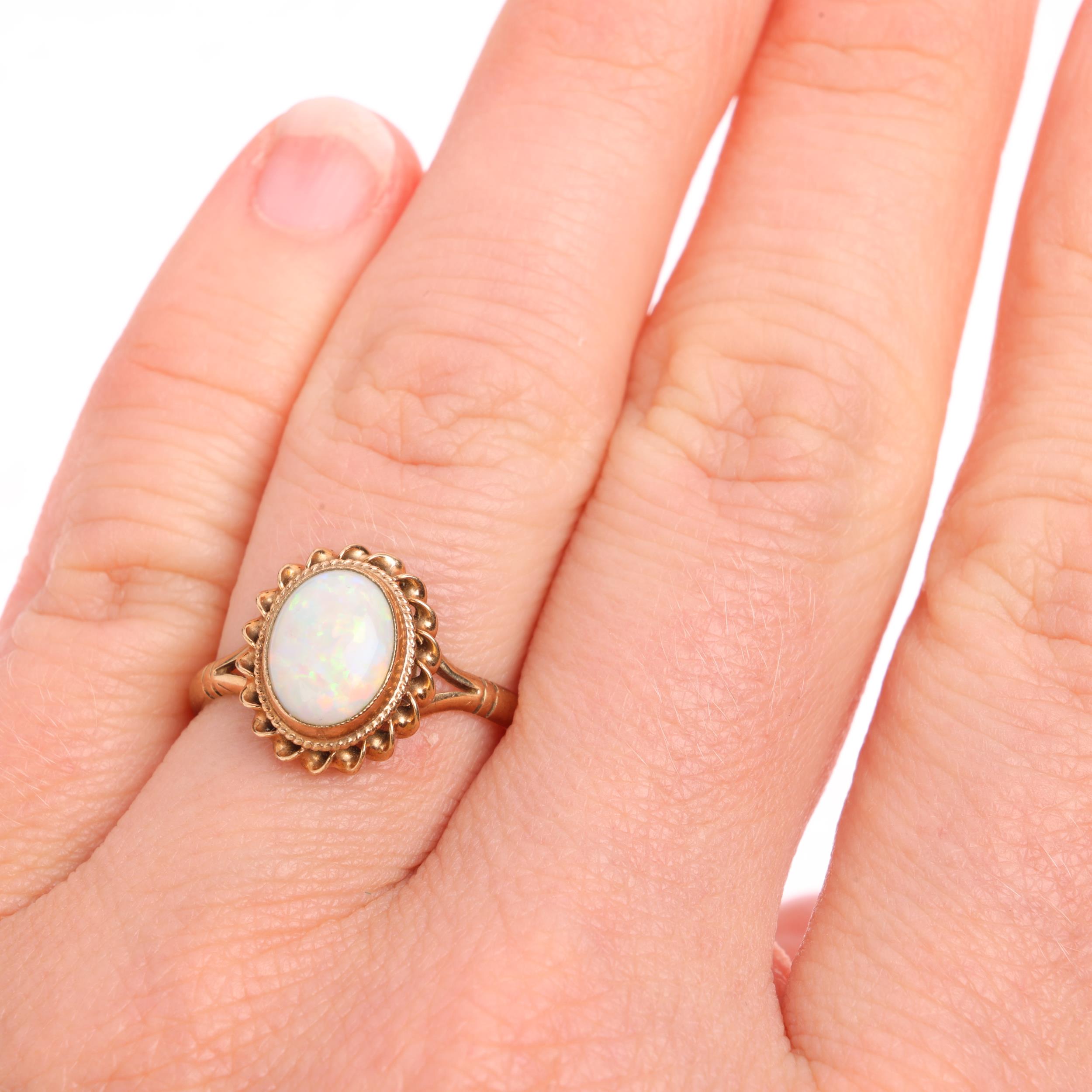 A 9ct gold solitaire opal dress ring, maker CG&S, Birmingham 1986, rub-over set with oval cabochon - Image 4 of 4