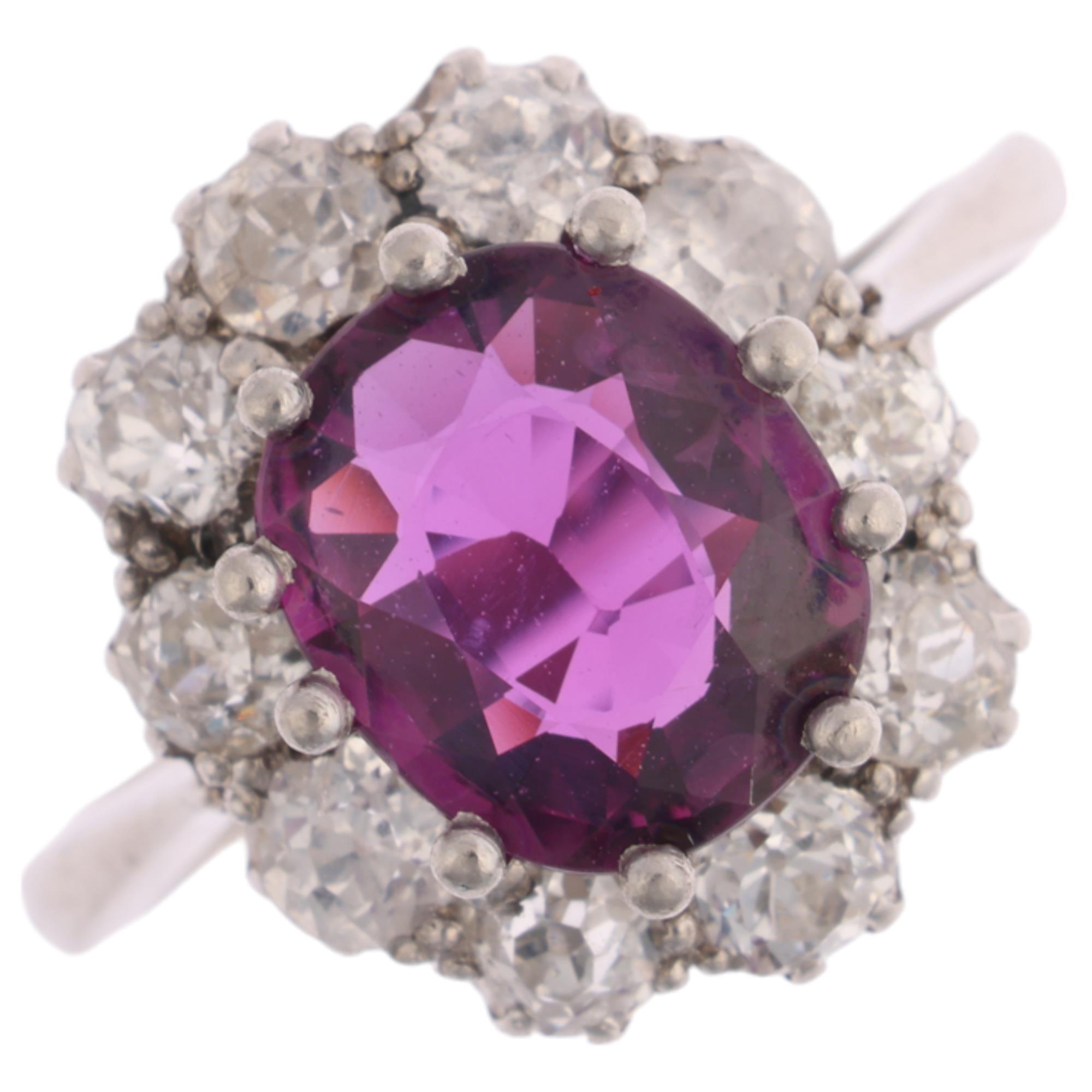 A platinum synthetic ruby and diamond flowerhead cluster ring, claw set with oval mixed-cut