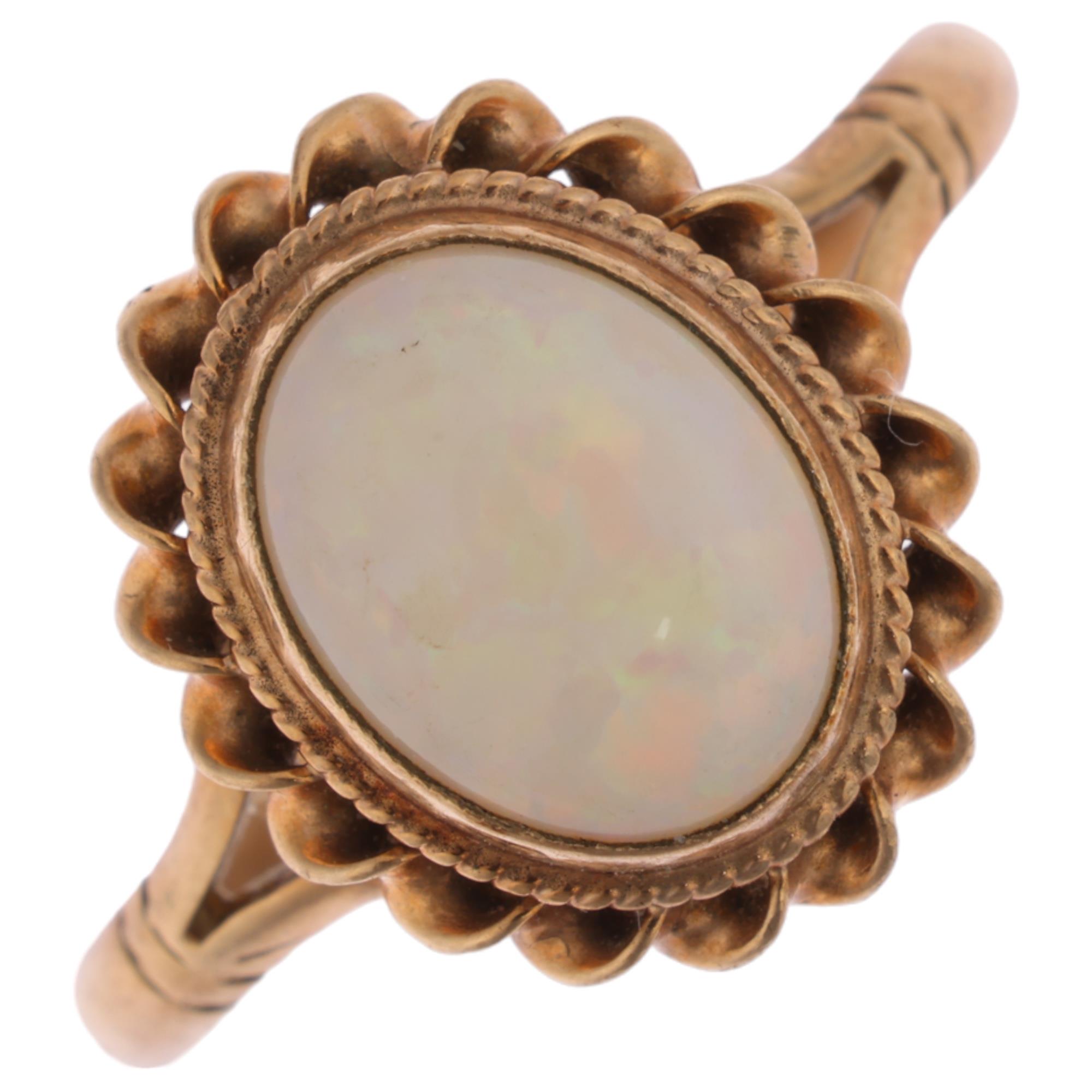 A 9ct gold solitaire opal dress ring, maker CG&S, Birmingham 1986, rub-over set with oval cabochon