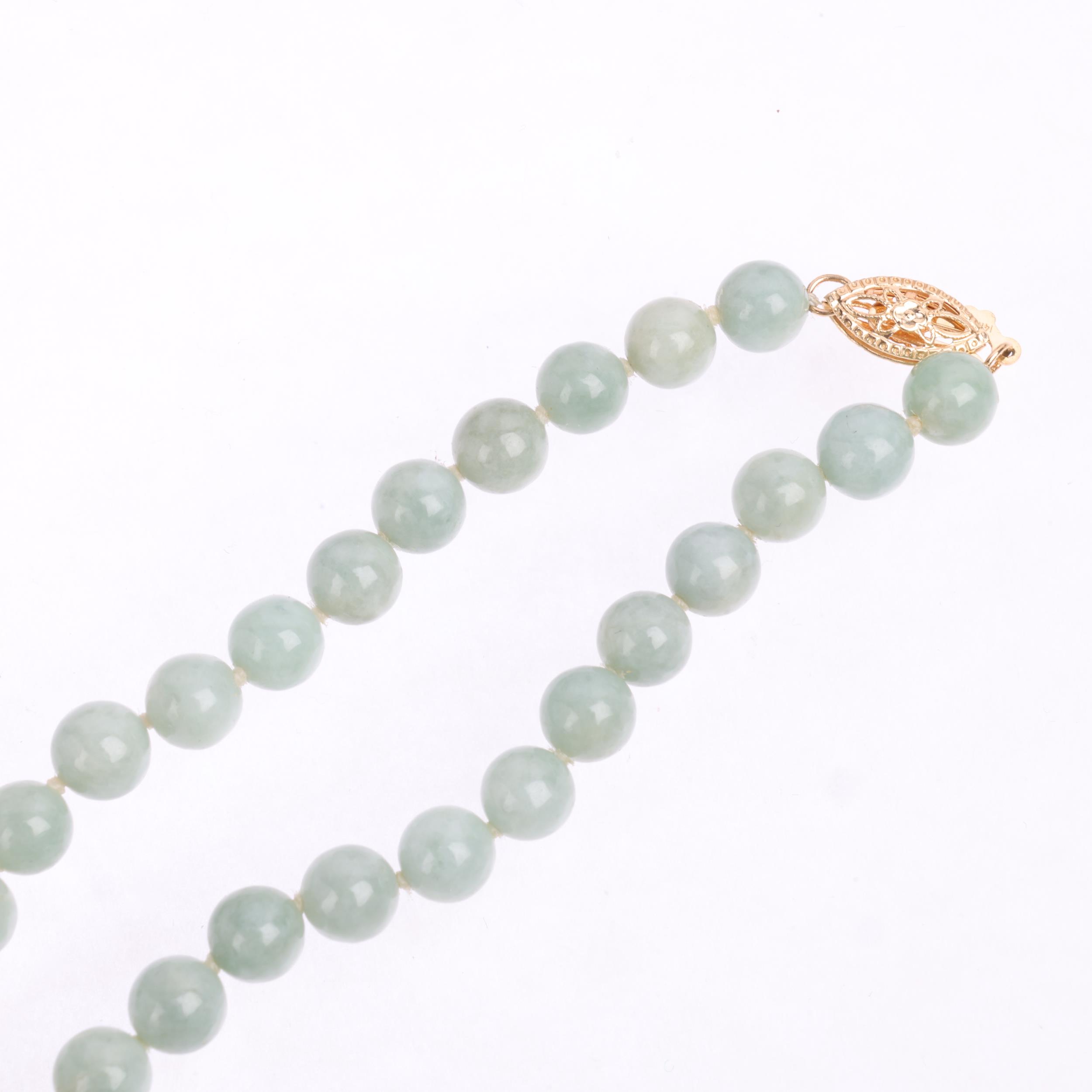 A single-row polished jade bead necklace, with 14ct gold clasp, beads measure 6.1mm, 44cm, 27.3g - Image 2 of 4